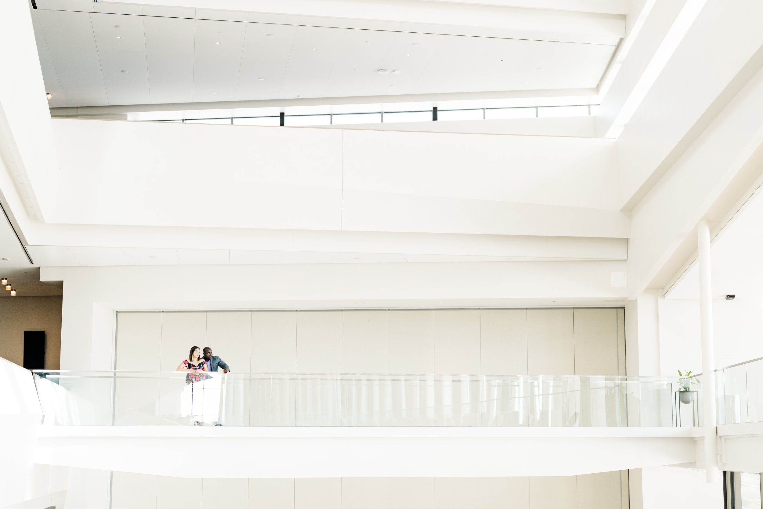 Engagement photo session with couple at an indoor location with a bright and airy vibe.