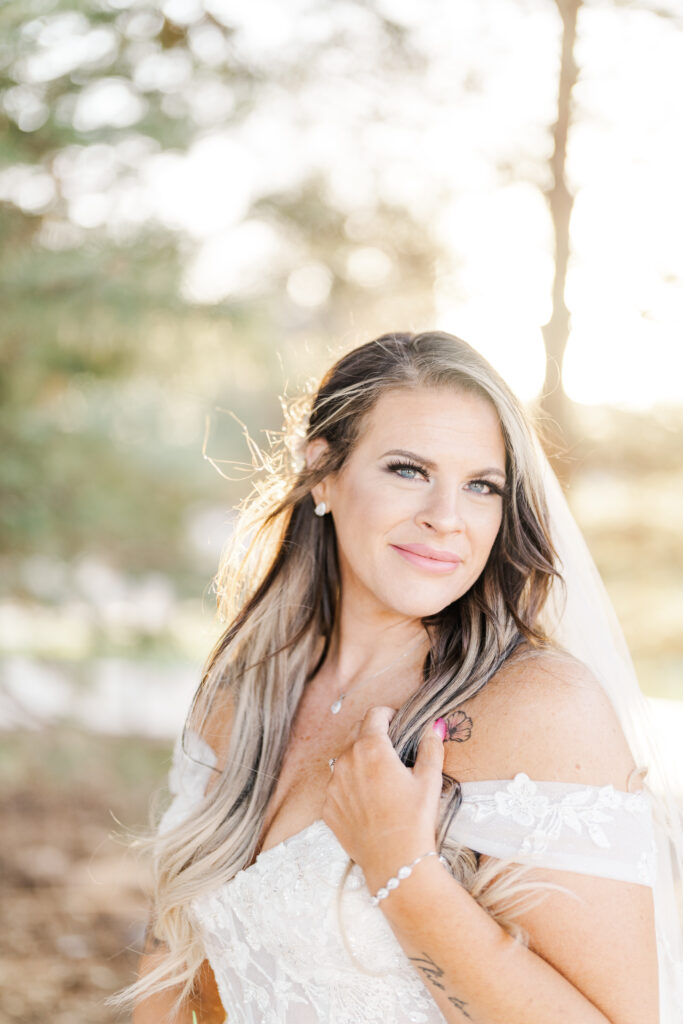 Bridal photography with bride in outdoor natural light with a fitted wedding gown and tattoos who is plus size. 