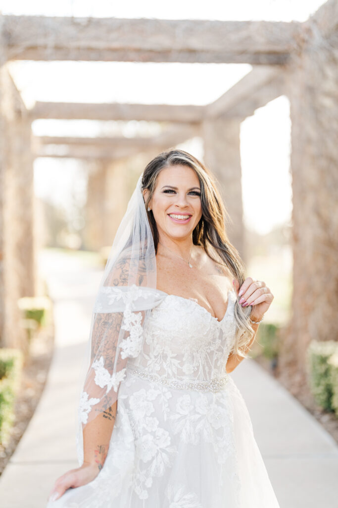 Bridal photos with a plus size bride smiling at the camera 